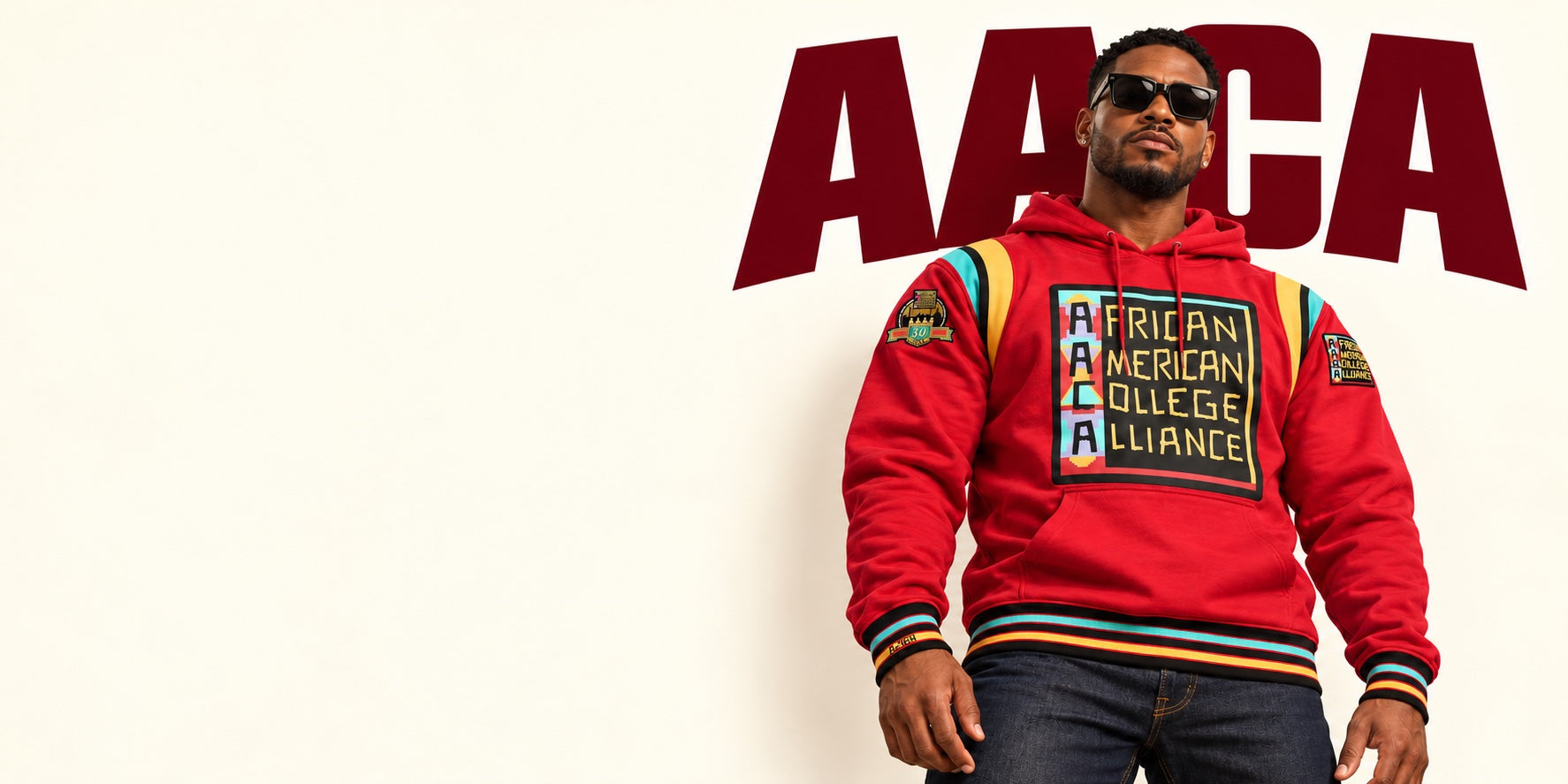 AACA winter campaign: model wearing a red anniversary hoodie with college-inspired patches and striped trim