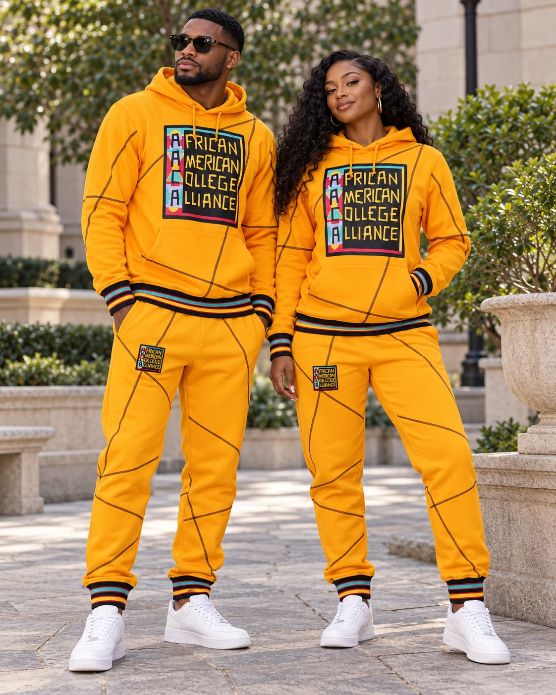 Male and female models wearing this matching AACA Logo hoodie and joggers