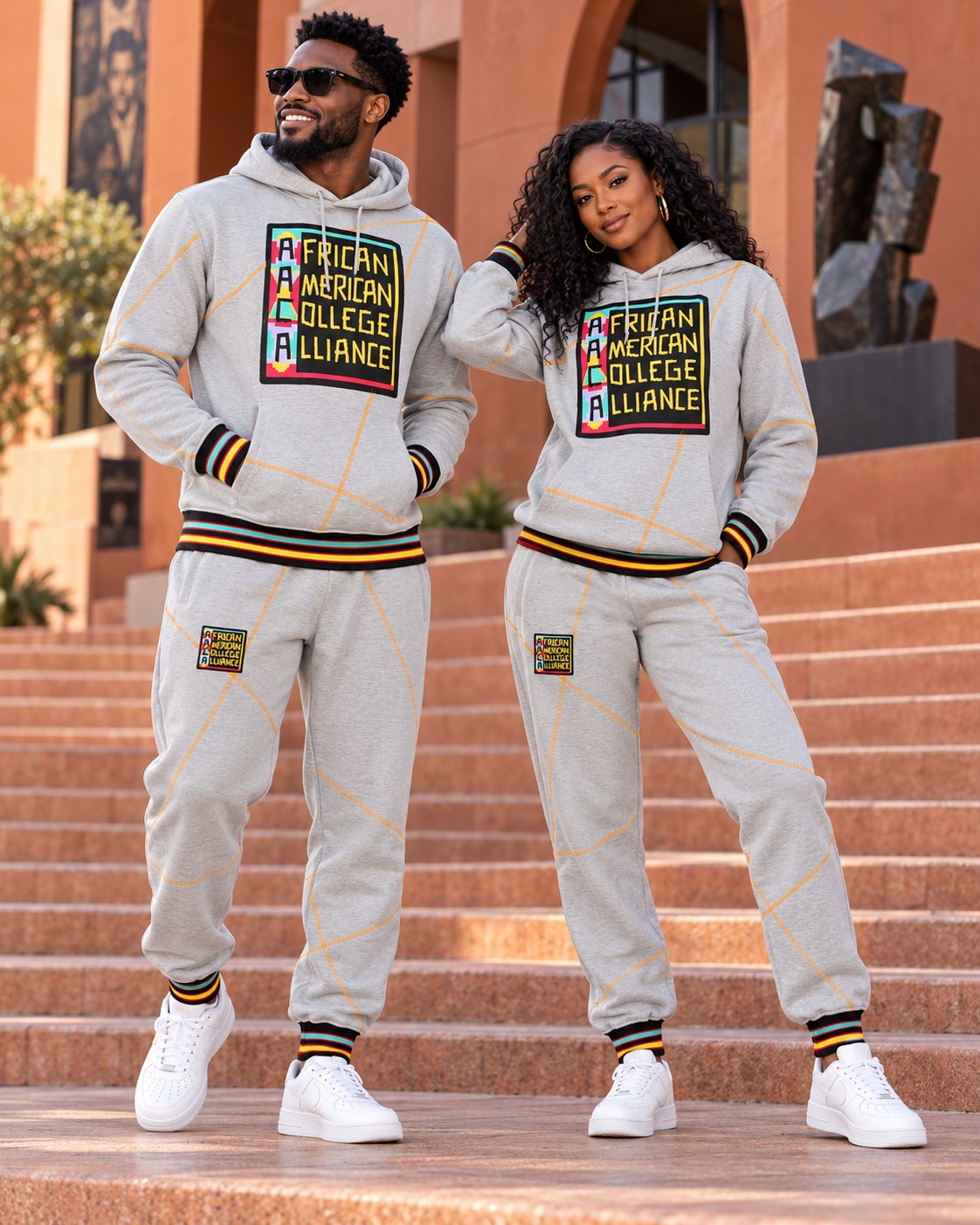 Male and female models wearing the matching AACA Logo hoodie and joggers